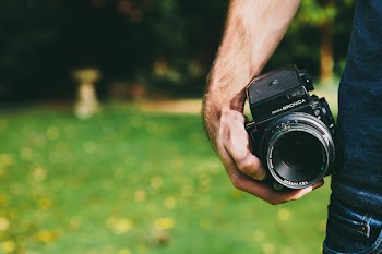 Person Holding Black Dslr Camera