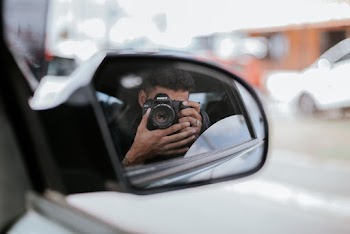 Person Holding Black Dslr Camera