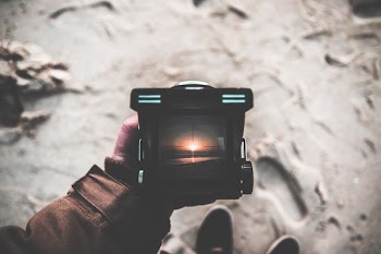 person holding black framed lamp