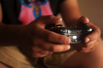 Person Holding Black Game Controller