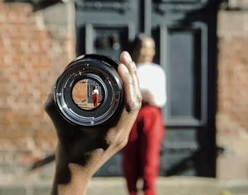 Person Holding Black Metal Zoom Lens