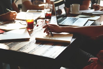 Person Holding Black Pen While Sitting · Free Stock Photo