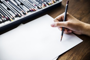 Person Holding Black Pencil