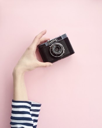 Person Holding Black Point-and-shoot Camera
