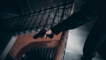 Person Holding Black Semi-automatic Pistol