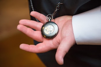 Person Holding Black Skeleton Pocket Watch
