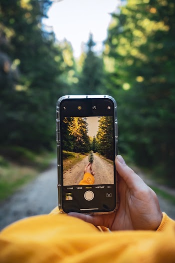 Person Holding Black Smartphone Taking Photo of Road
