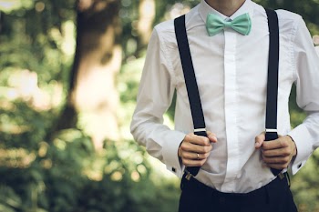 Person Holding Black Suspenders