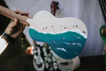 Person Holding Blue And White Painted Ukulele