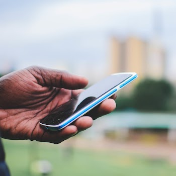 Person Holding Blue Smartphone