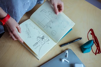 Person Holding Book in Room