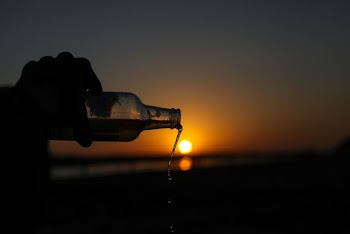 Person Holding Bottle
