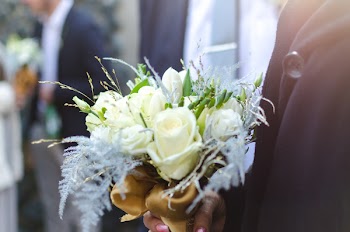 Person Holding Bouquet of White Roses