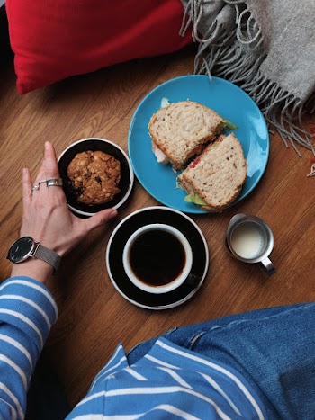 Person Holding Bowl of Food on Floor