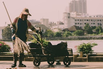 Person Holding Broom And Cart