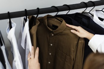 Person Holding Brown Dress Shirt