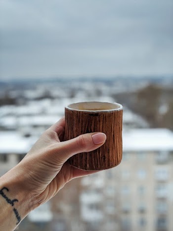 Person Holding Brown Mug