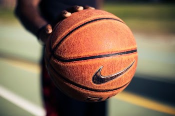 person holding brown Nike basketball