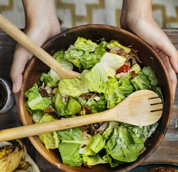 Person Holding Brown Wooden Bowl With Vegetable Salad Inside