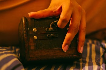 Person Holding Brown Wooden Chest