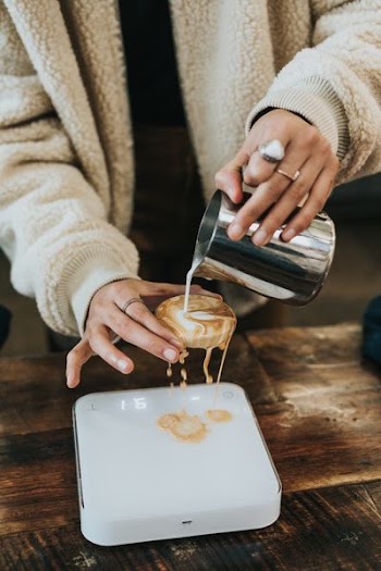 person holding bun pouring milk