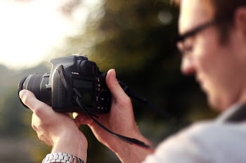 Person Holding Camera during Day Time