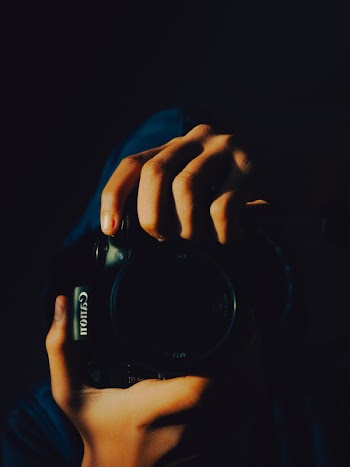Person Holding Canon Camera