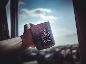 Person Holding Ceramic Mug