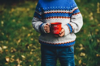 person holding ceramic mug