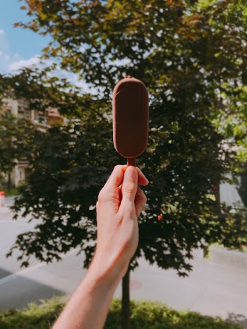 Person Holding Chocolate Popsicle