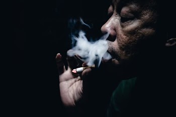 person holding cigarette