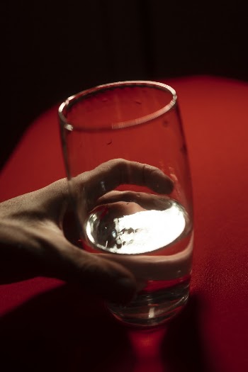Person Holding Clear Drinking Glass