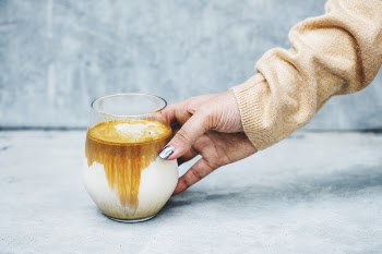 Person Holding Clear Drinking Glass