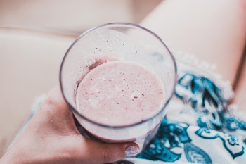 Person Holding Clear Drinking Glass With Fruit Shake Close-up Photo