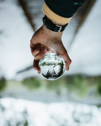 Person Holding Clear Glass Ball
