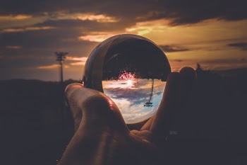 Person Holding Clear Glass Ball