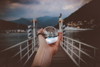 Person Holding Clear Glass Ball