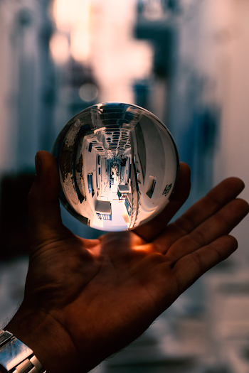 Person Holding Clear Glass Ball