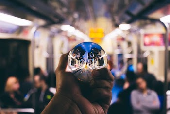 Person Holding Clear Glass Ball