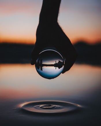 Person Holding Clear Glass Ball