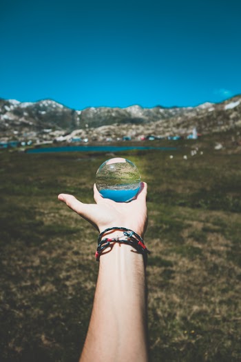 Person Holding Clear Globe Ball