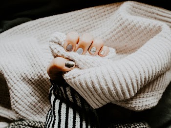 Person Holding Coat With Manicured Nails