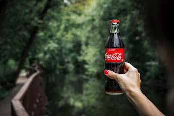 Person Holding Coca-cola Bottle