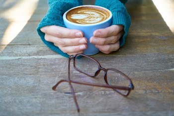 Person Holding Coffee Latte