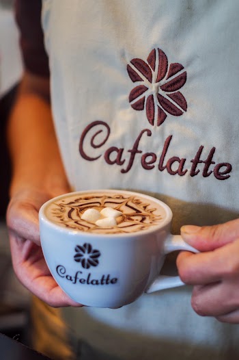Person Holding Coffee Latte