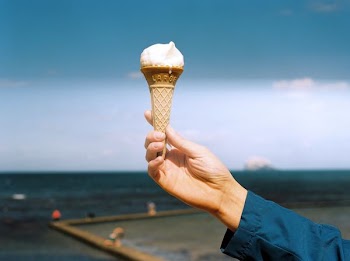 person holding cone with ice cream