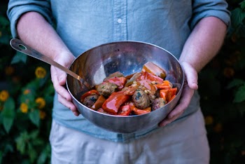 Person Holding Cooked Dish on Gray Stainless Steel Bowl