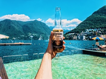 Person Holding Corona Extra Bottle