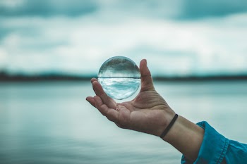 Person Holding Crystal Ball