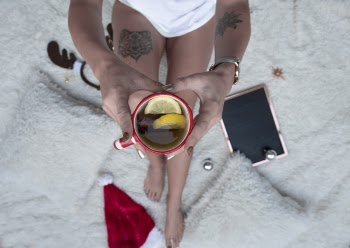 Person Holding Cup Filled With Brown Liquid